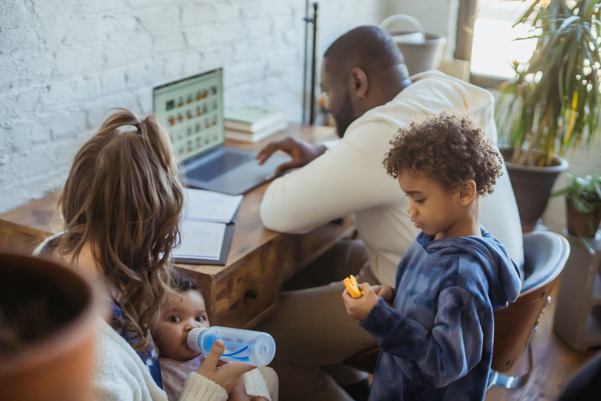 Deux parents et leurs enfants partagent un moment de vie dans leur salon